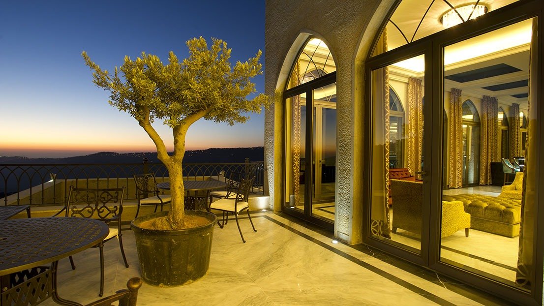 Evening view of a small hotel terrace and lounge area — symbolizing comfort and modern hotel management.